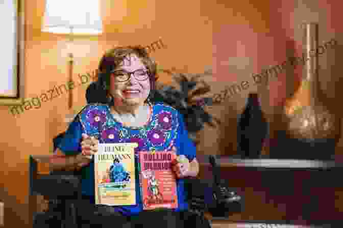 Judy Heumann, A Woman In A Wheelchair, Smiling And Holding A Microphone Being Heumann: An Unrepentant Memoir Of A Disability Rights Activist